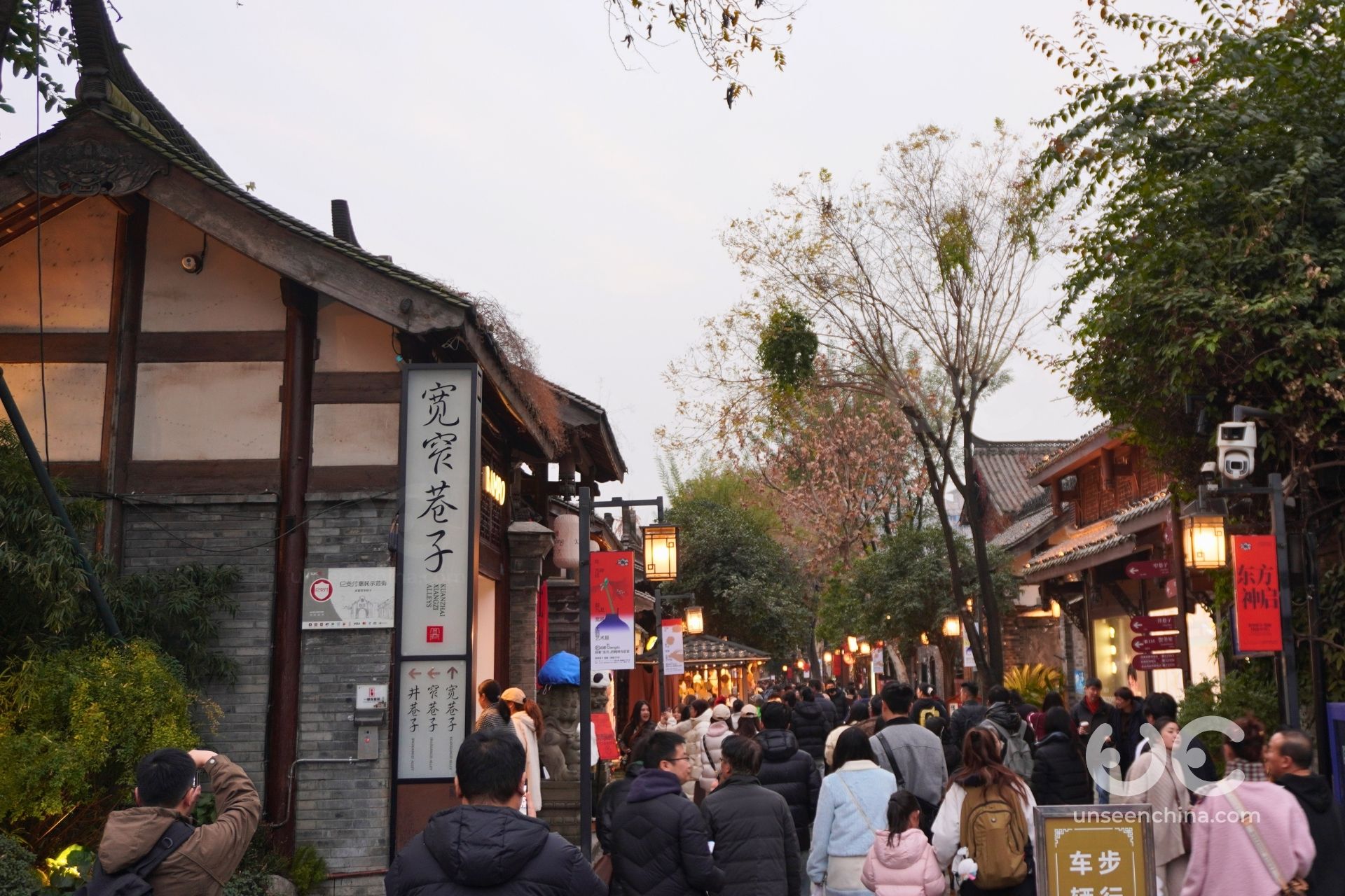 Busy entrance to Kuanzhai Alley with crowds of tourists entering the attraction.